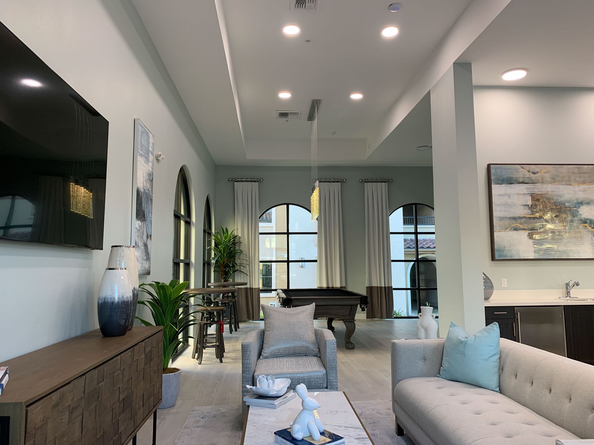 a living room with a pool table and a couch