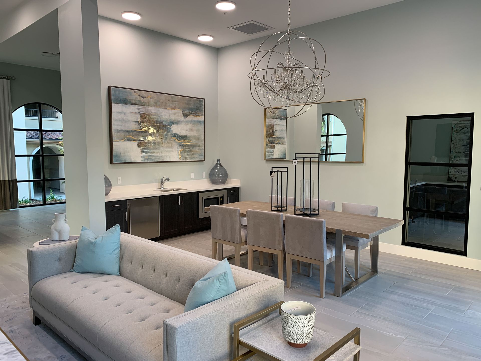 a living room with a couch , table and chairs .