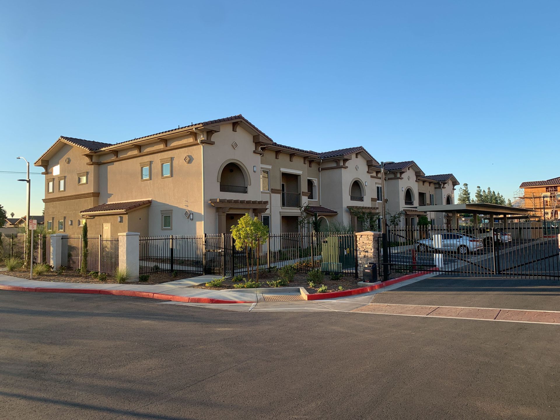 a row of apartment buildings are lined up on the side of a road .