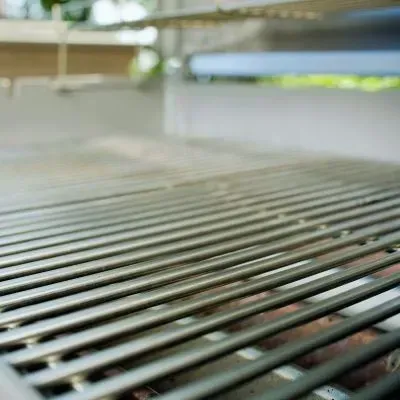 Cleaned BBQ grill surface after outdoor tidying work, showing a refreshed cooking area in East Taieri, Mosgiel.