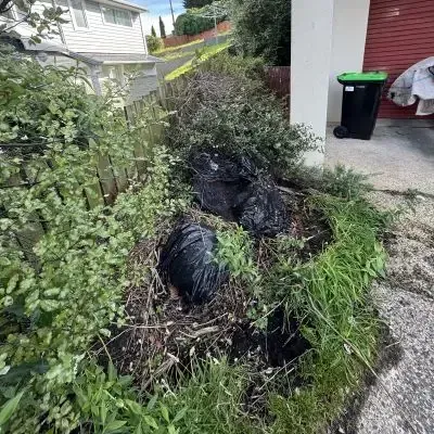 Before: bags of waste and garden debris piled in a front section area in North Dunedin.