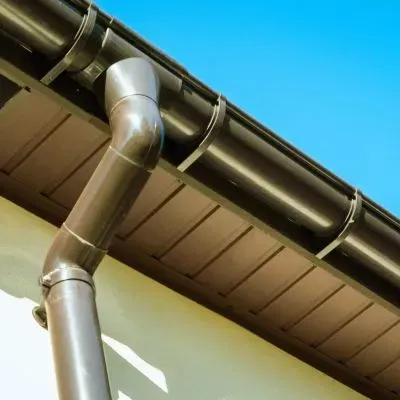 A clean gutter and downpipe on a one-storey home showing compliant stormwater drainage in Dunedin.