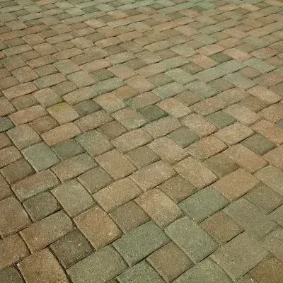 Recently pressure-washed paver driveway showing clean, well-maintained exterior surfaces.