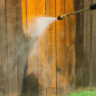 Controlled water blasting on a timber surface using surface-appropriate pressure in Dunedin.
