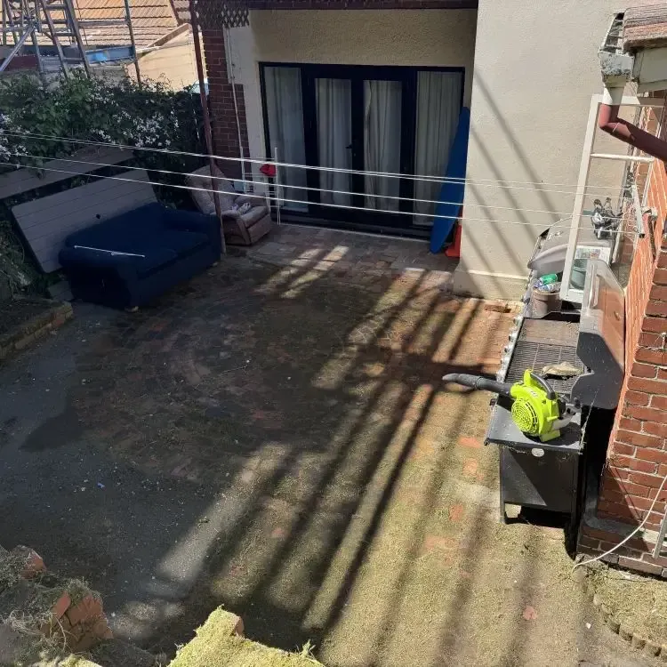 After: Courtyard cleaned up with grass patches and weeds removed, resulting in a tidy outdoor space in Opoho, Dunedin.