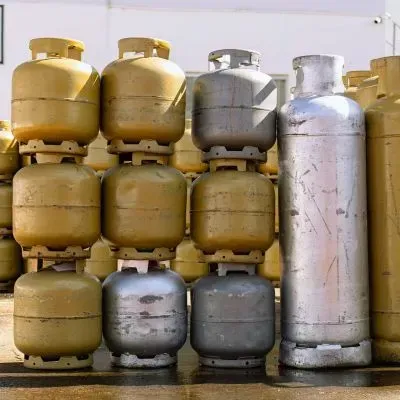 Gas canisters are stored upright to illustrate items that may require assessment before safe removal in Dunedin.