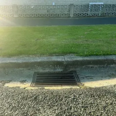 Residential stormwater drain in Dunedin illustrating runoff control and compliance with the Stormwater Quality Bylaw.