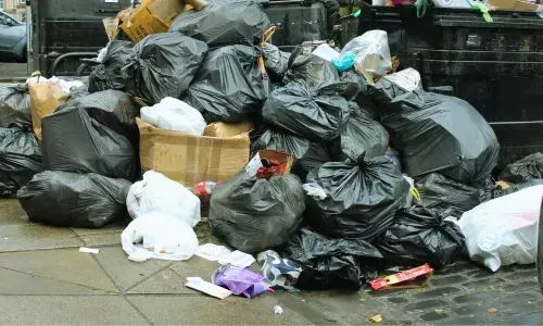 General waste bags are piled for collection in Dunedin Central.