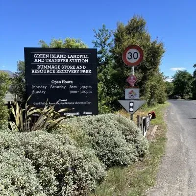 Entrance sign for the Green Island Transfer Station in Dunedin showing official DCC waste facility information.