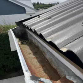After: Gutter cleaning job completed, removing leaves and debris from the roofline in Bradford, Dunedin.
