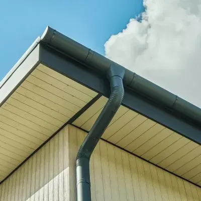 Gutter and downpipe on a one-storey home showing residential stormwater drainage system in Dunedin.