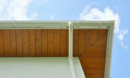 A clean gutter and downpipe on a one-storey home showing a healthy roof drainage system in Dunedin.