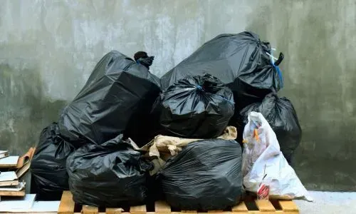 Neatly grouped household rubbish on a pallet prepared for collection in Dunedin.