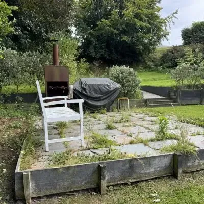 Before: Landscaping maintenance and garden clean-up for a client's weed-covered paved patio area, St Clair, Dunedin.