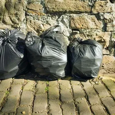 Neatly bagged household rubbish in Dunedin is ready for compliant waste collection and disposal.
