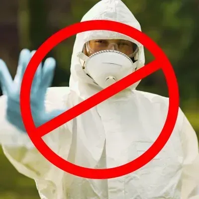 Protective-suit worker with a prohibition symbol to show that asbestos removal is not offered by FORUDUNEDIN.