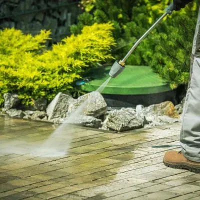 Pressure washing exterior pavers during a cost-effective water blasting job, showing typical pricing work in Dunedin, Otago.