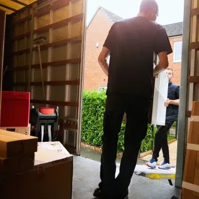 Team loading household items into a trailer, providing a compliant rubbish clearance job in Dunedin.