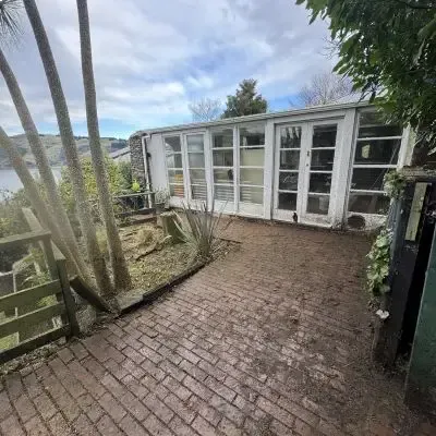 After: Property tidy up services turning overgrown weeds on a paved driveway into a clear and clean look.