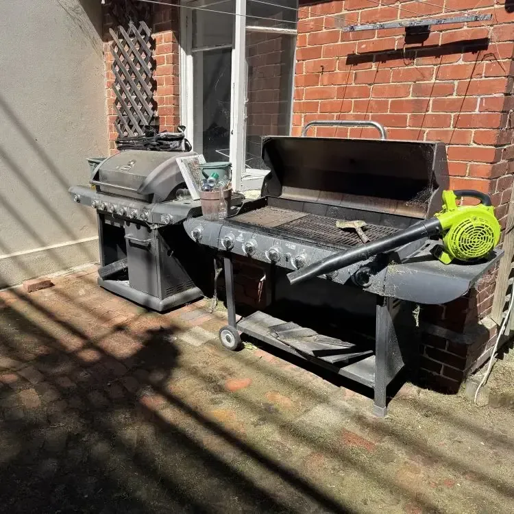 After: Couch was disposed of, resulting in a tidy courtyard with weed removal from the foundation, North Dunedin, Dunedin.