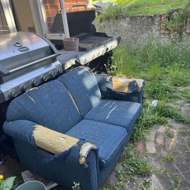 Before: Old couch taking up space in a courtyard in North Dunedin, Dunedin.