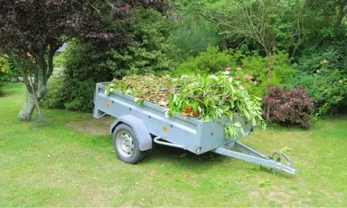 Green waste trailer after overgrown garden clearing in Dunedin, illustrating section clearing costs and project scale.