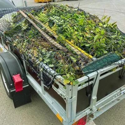 Trailer loaded with secured green waste in Dunedin, ready for transport to an approved disposal facility.