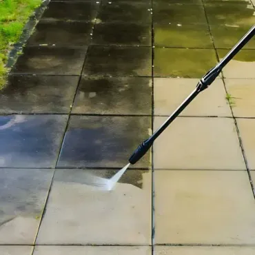 Pressure-washing expert providing water blasting services for patio pavers, showcasing before-and-after results.