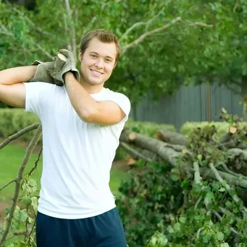A FORUDUNEDIN gardening team member delivering professional yard and section clean-up services for an overgrown property.