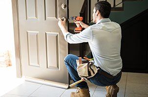 Man Fixing Residential Door - Lockout Services in Davenport, IA