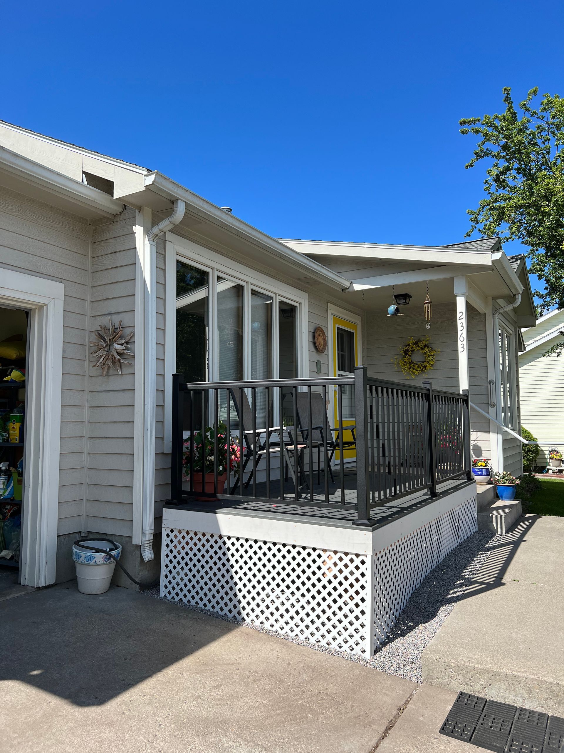 A house with a porch and a clock on the wall