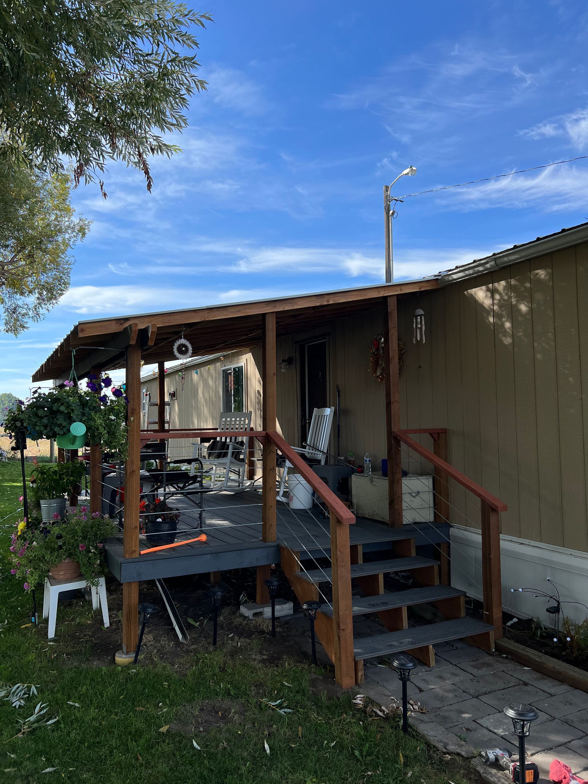 A mobile home with a porch and stairs