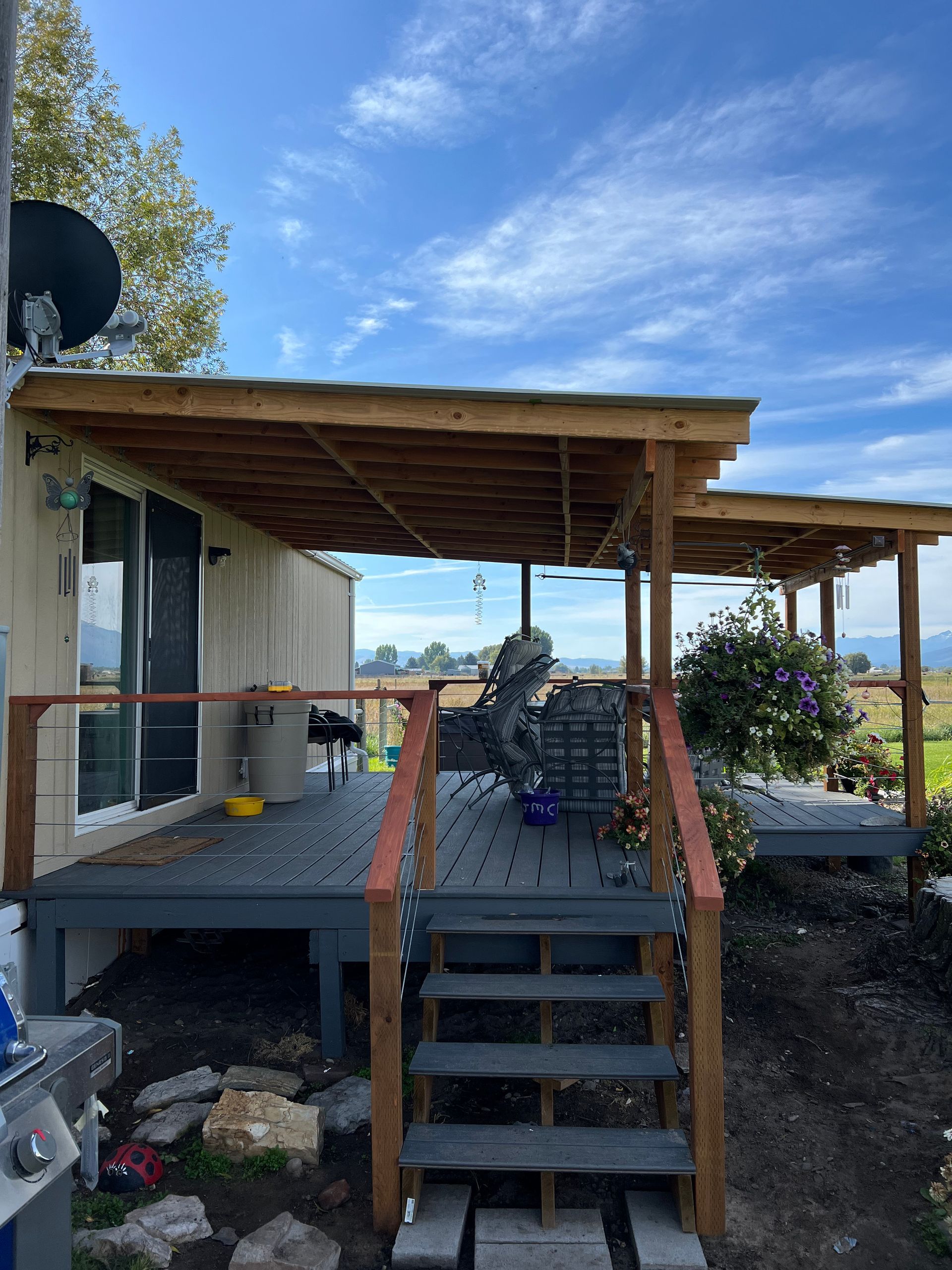 A wooden deck with stairs leading up to it