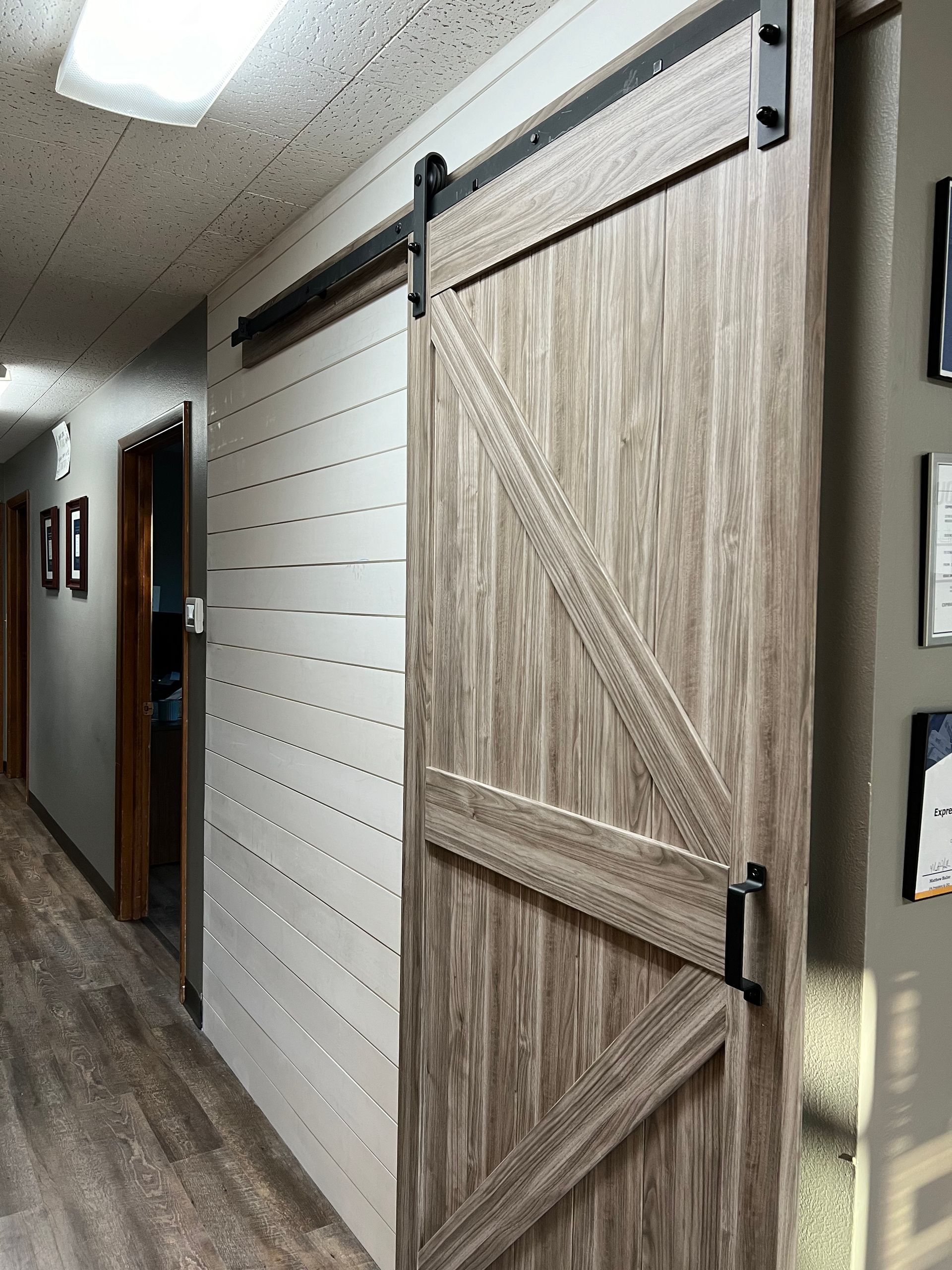 A hallway with a wooden sliding barn door