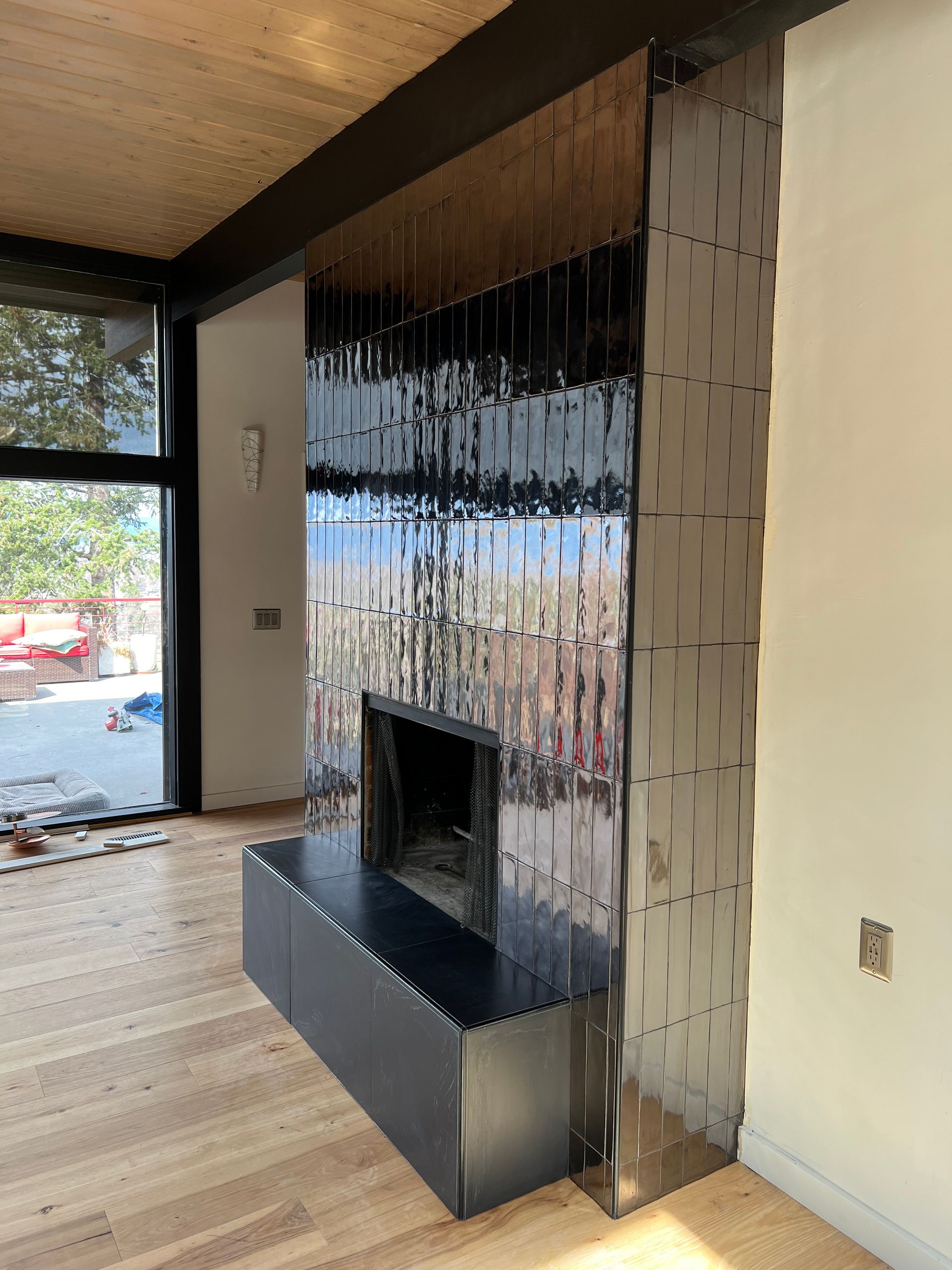 A living room with a fireplace and a large window