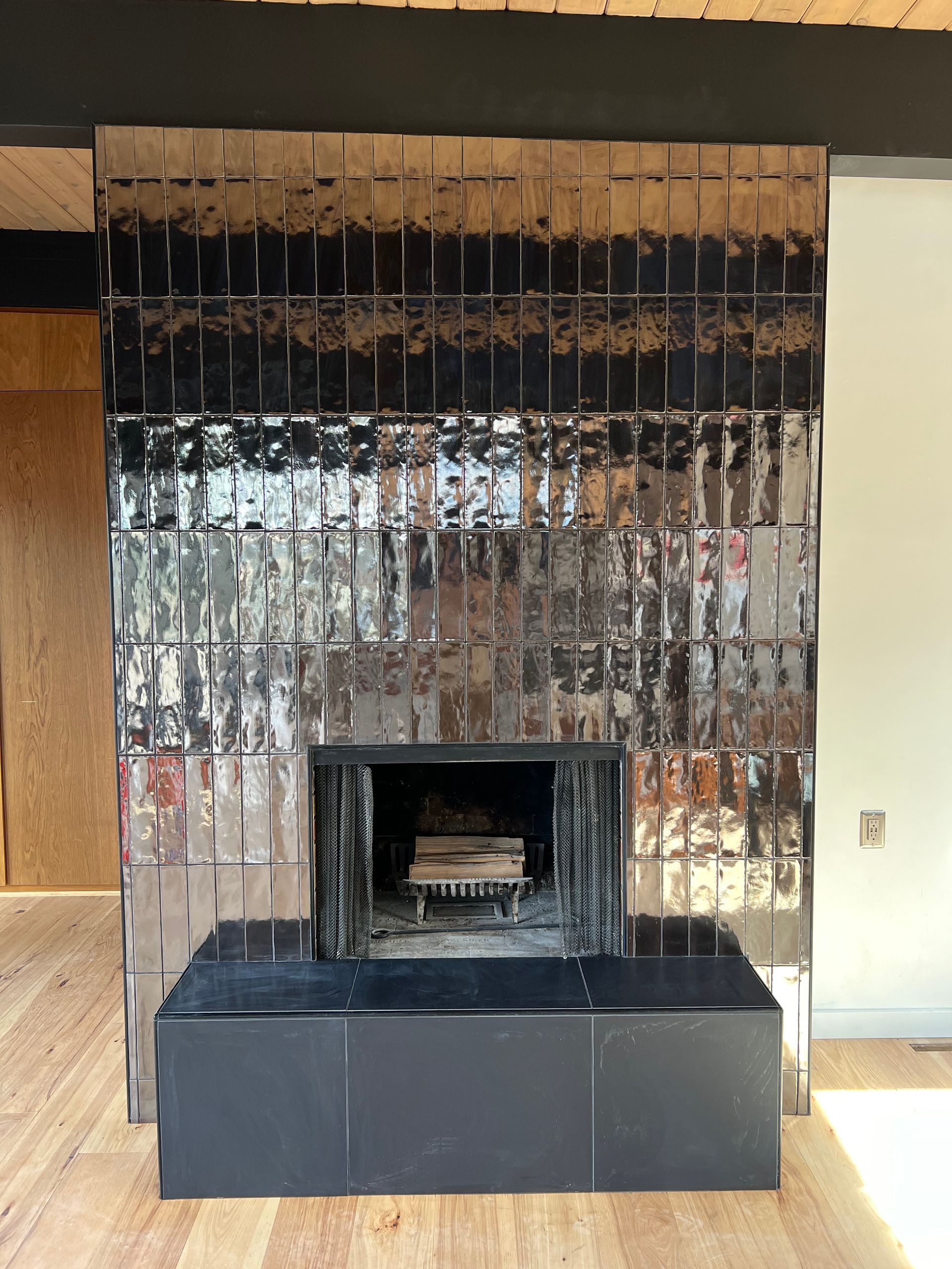 A fireplace in a room with a wooden floor