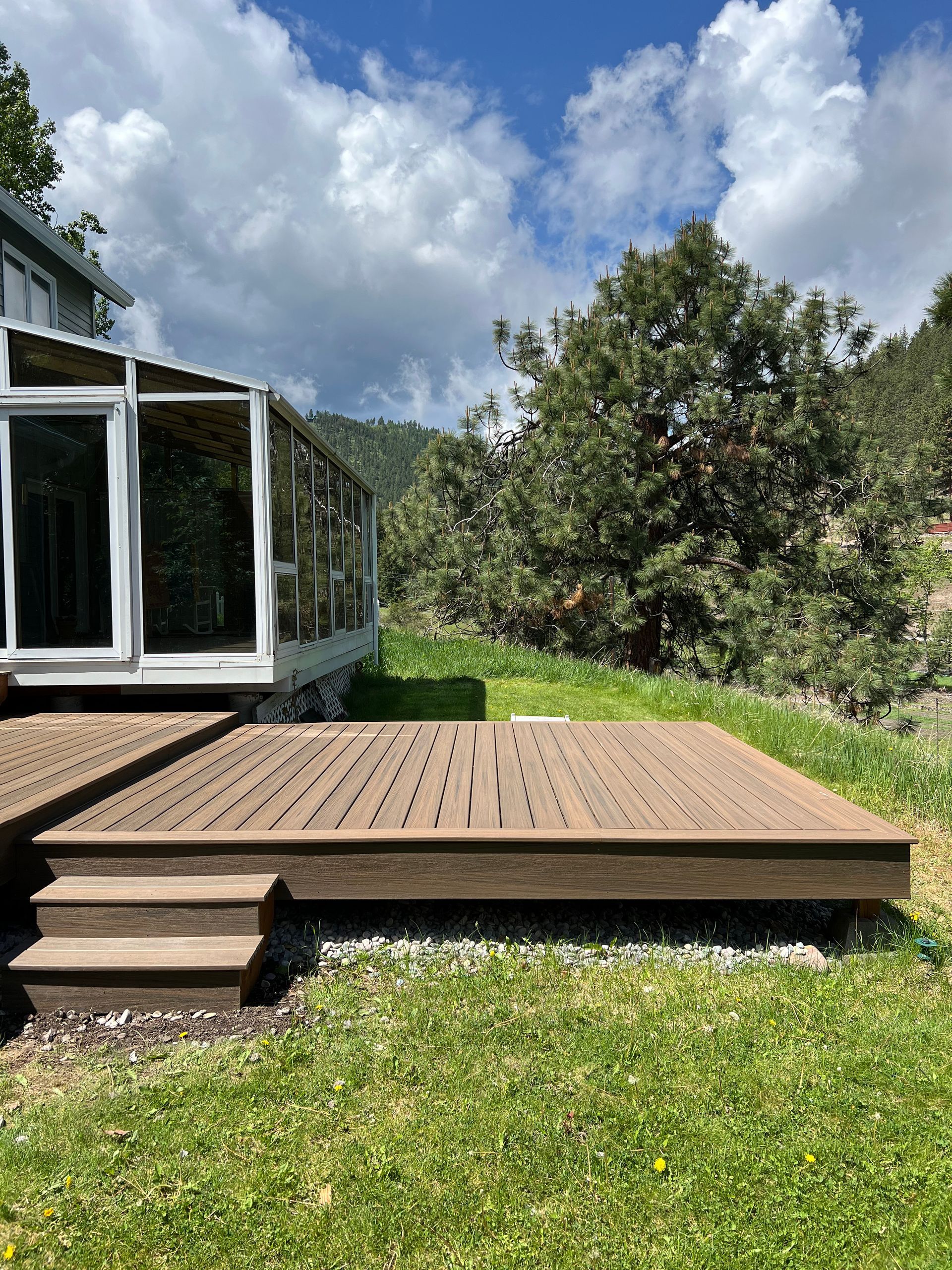 A house with a large deck in front of it.