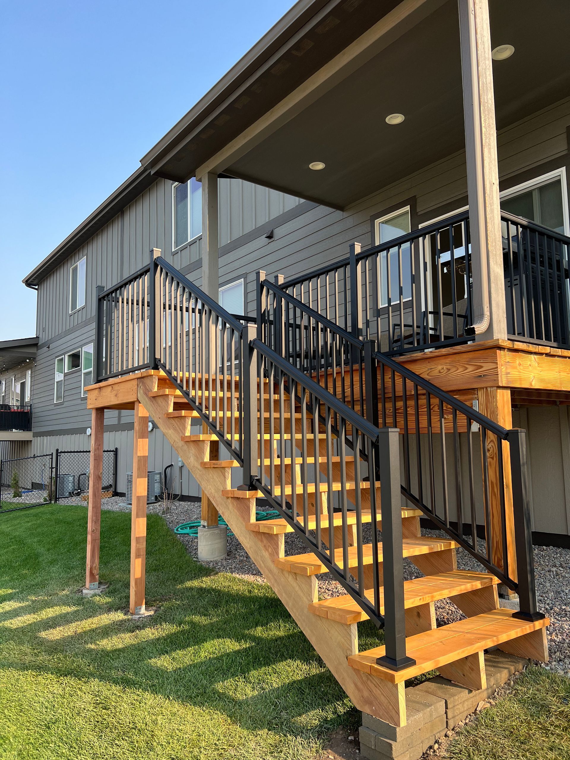 A wooden deck with stairs leading up to it