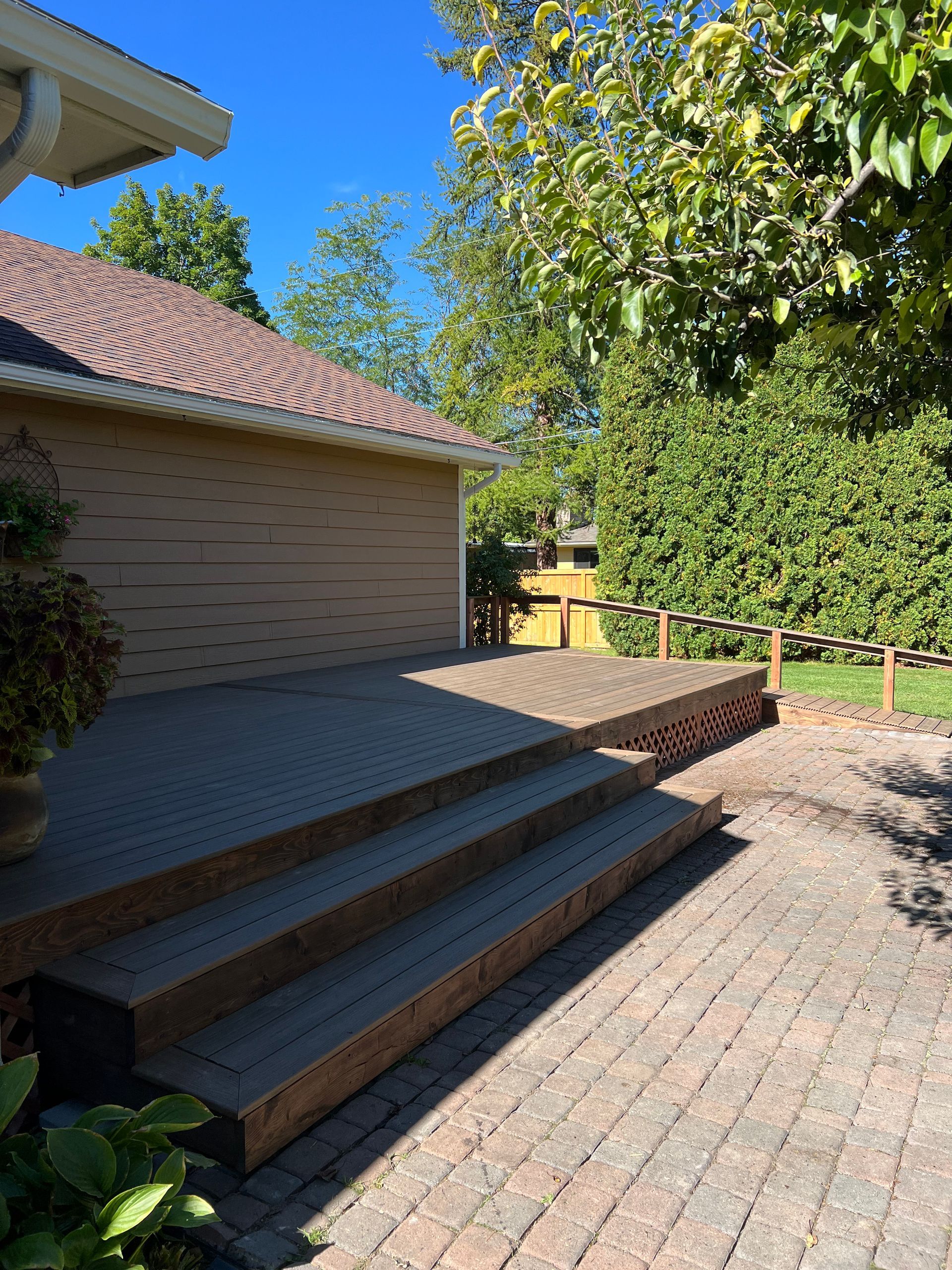 A house with a wooden deck and stairs leading up to it