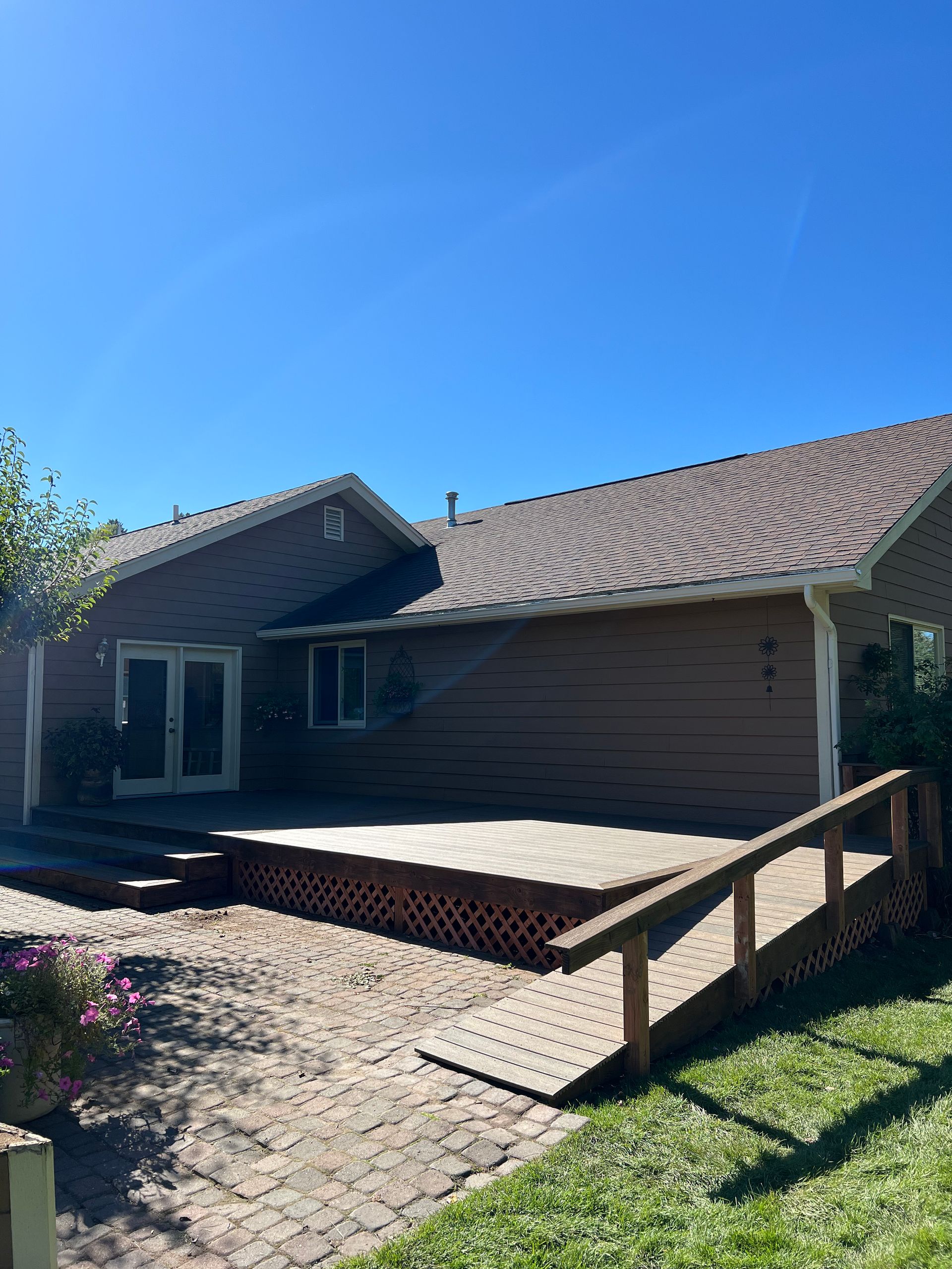 A house with a deck and a ramp in front of it