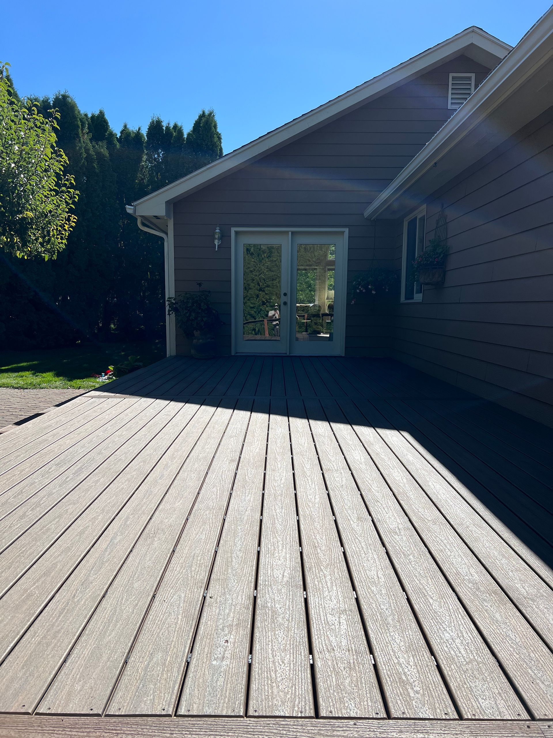 A house with a large deck and sliding glass doors