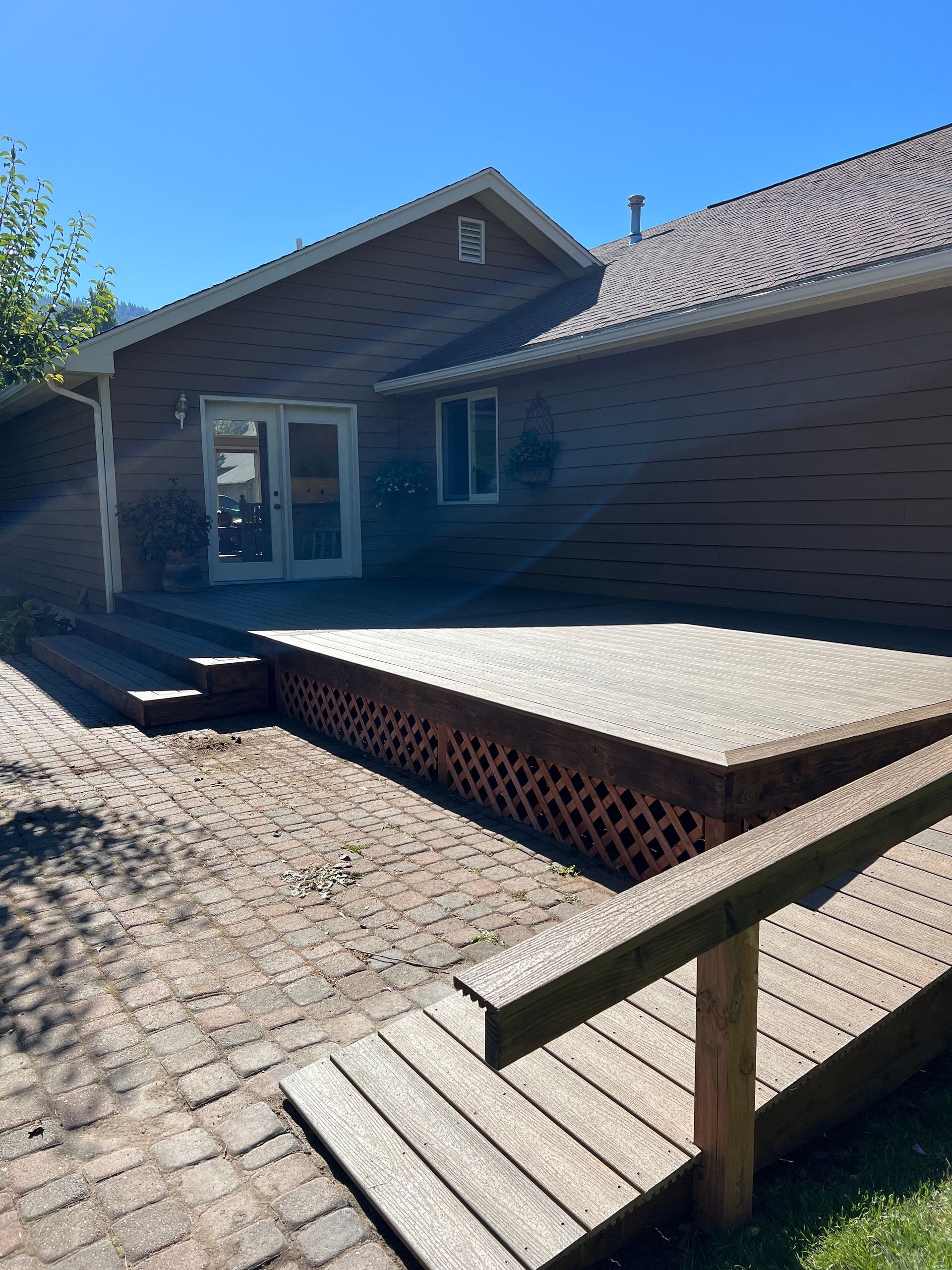 A house with a wooden deck in front of it