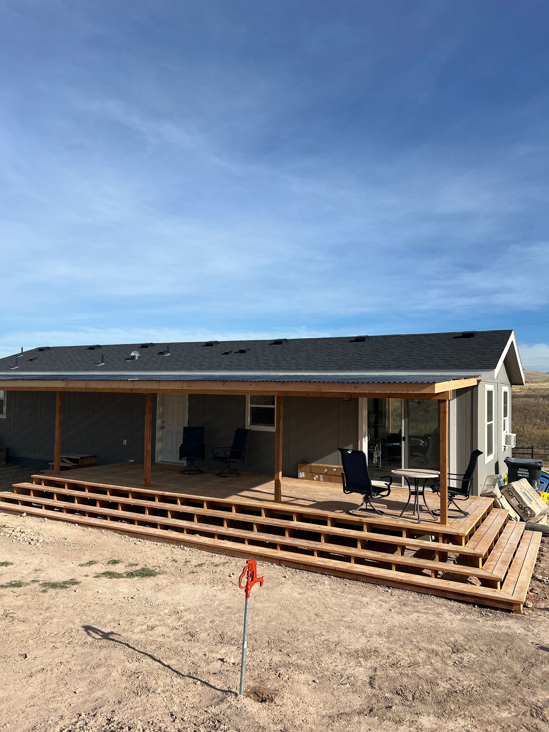 A house with a large porch and stairs leading up to it