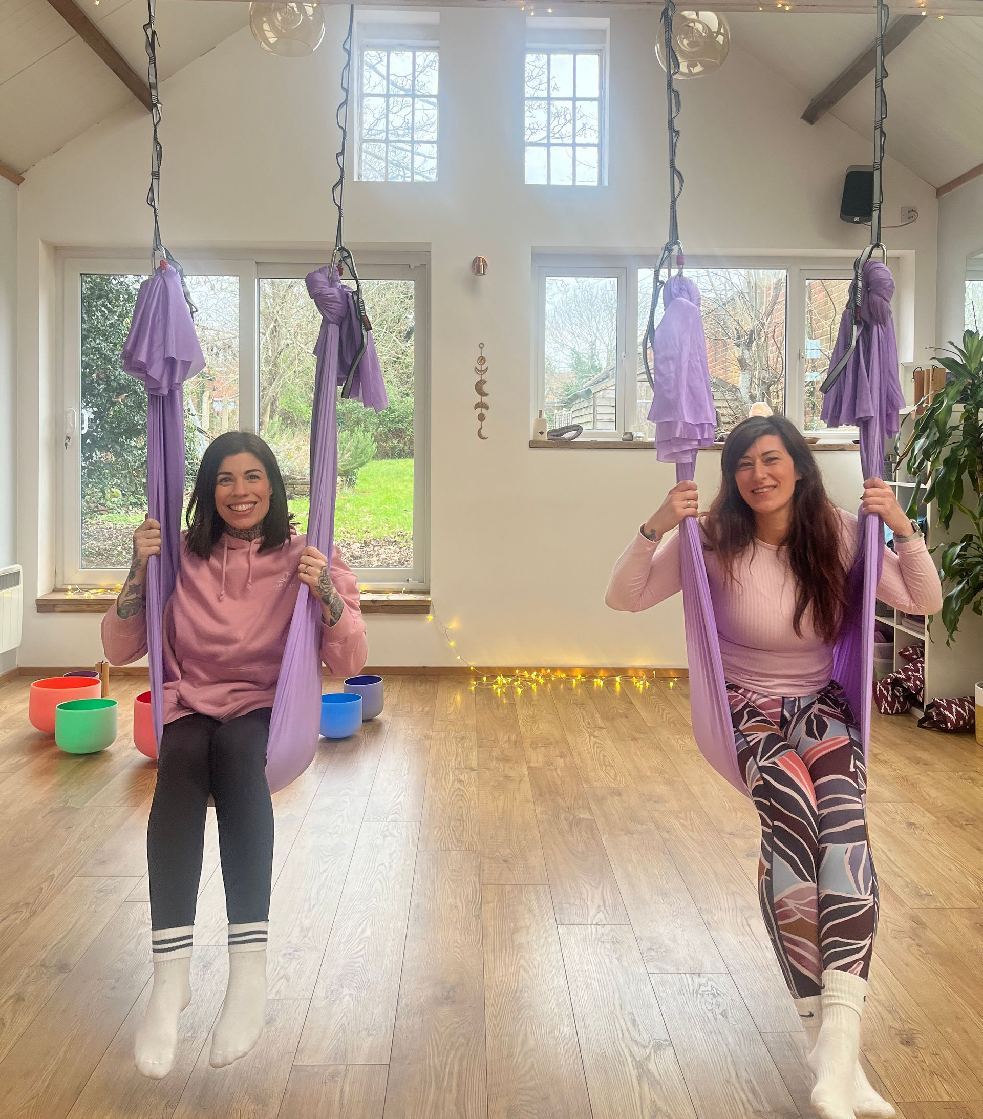 Two people stand in front of Woodley Village Hall entrance, beneath a wooden porch.