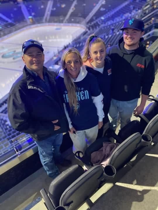 A group of people are posing for a picture in a stadium.