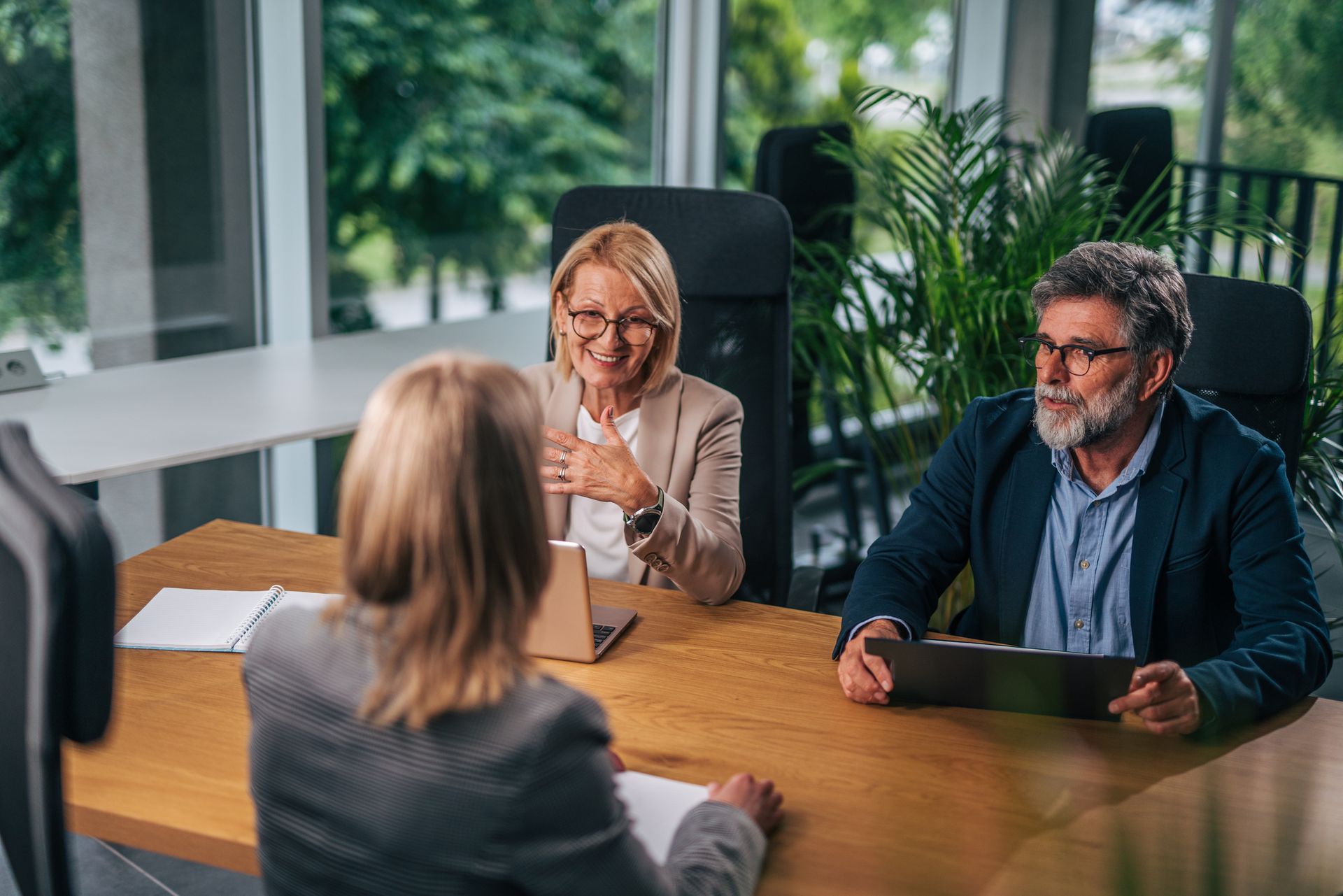 A man and a woman are sitting at a table having a job interview.