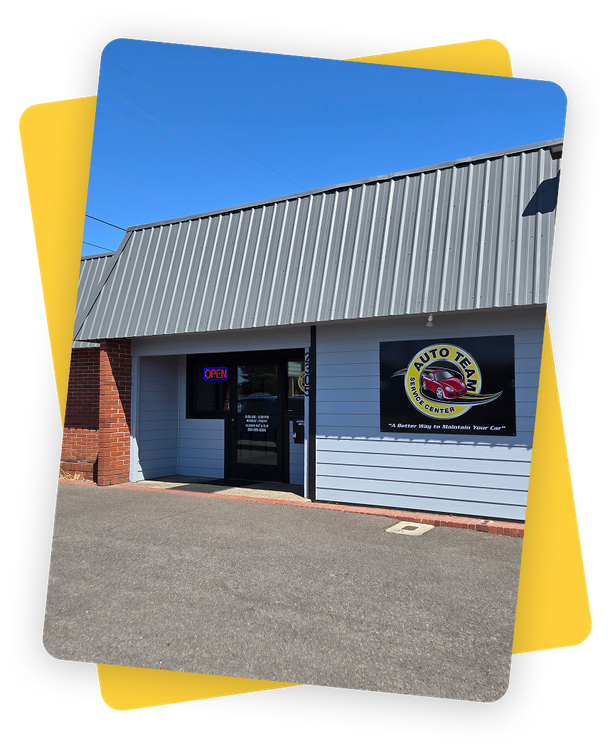 A picture of a brick building with a blue roof | Auto Team Service Center