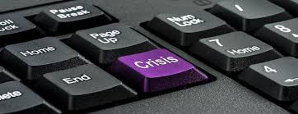 A close up of a keyboard with a purple crisis key.