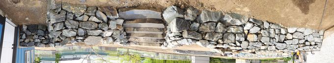 Stone retaining wall with steps.