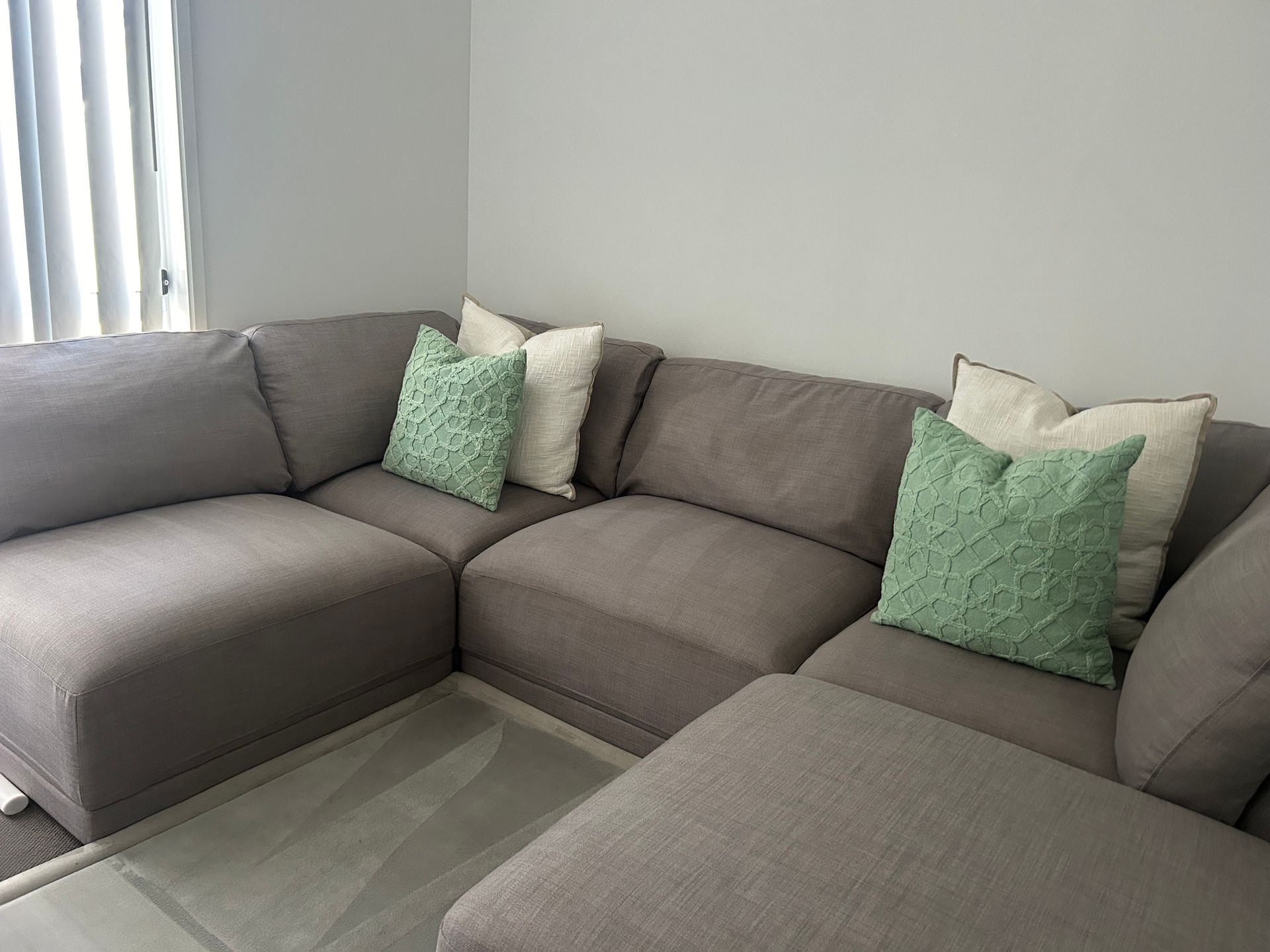 A Living Room With a Couch and Pillows — We Clean Lounges In Buddina, QLD